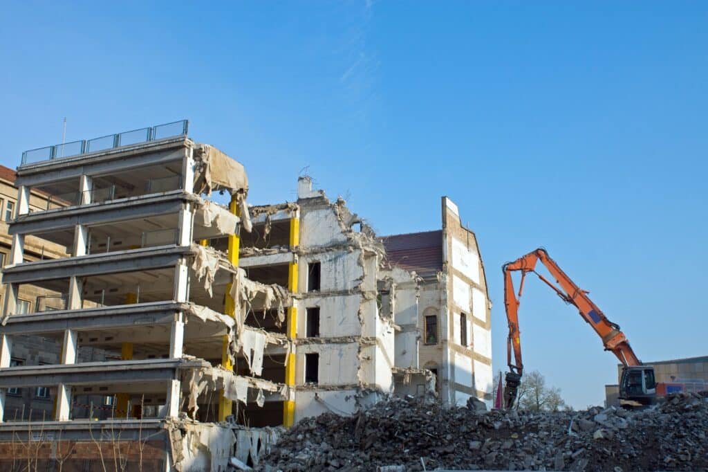 Demolition of a building with excavator